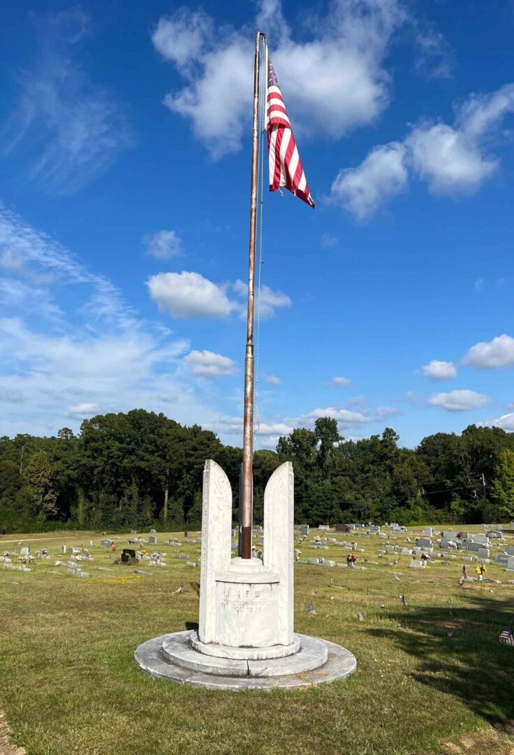 A flag pole with an american flag flying on it.